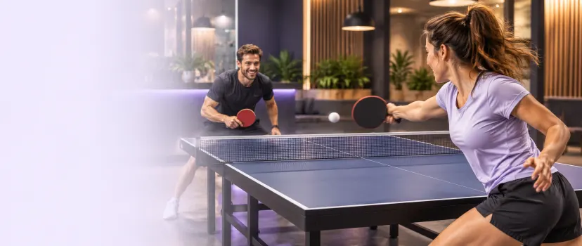 Two adult players enjoying a table tennis rally in a bright modern indoor venue